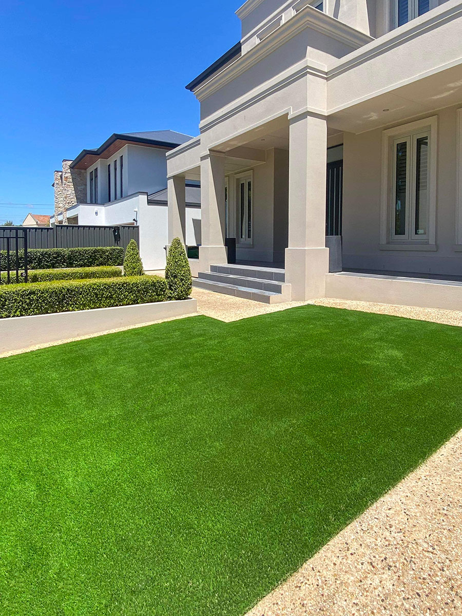 Artificial turf in the front yard of a large home