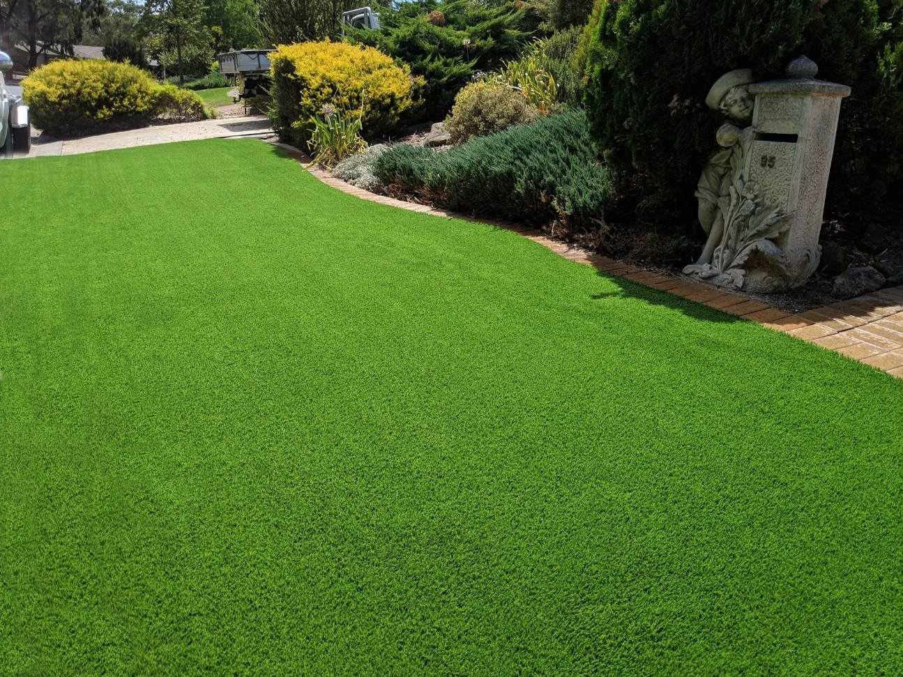 artificial turf next to a garden