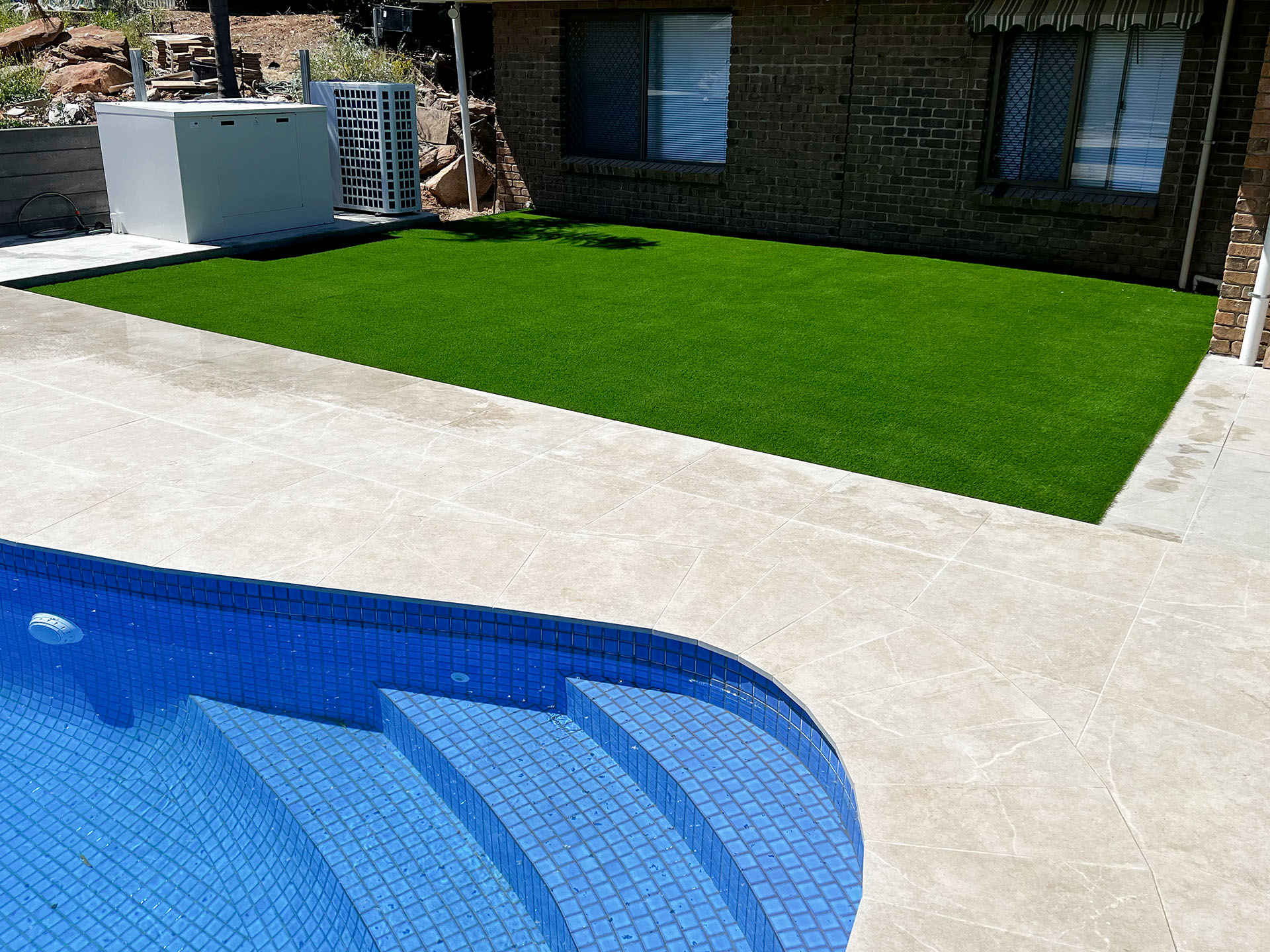 artificial turf next to a swimming pool