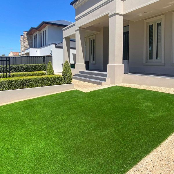 Artificial turf in the front yard of a large home