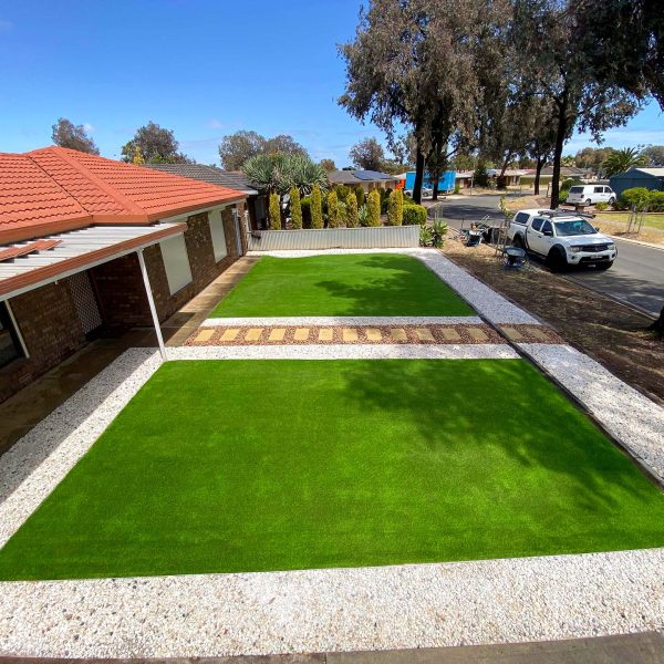 artificial turf in a front garden with a paved walkway down the centre