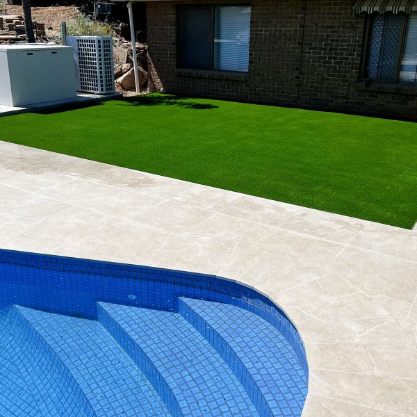 artificial turf next to a swimming pool